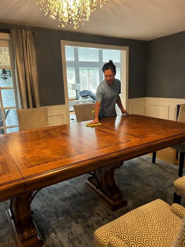 Bedigan cleaner polishing a wood dining table