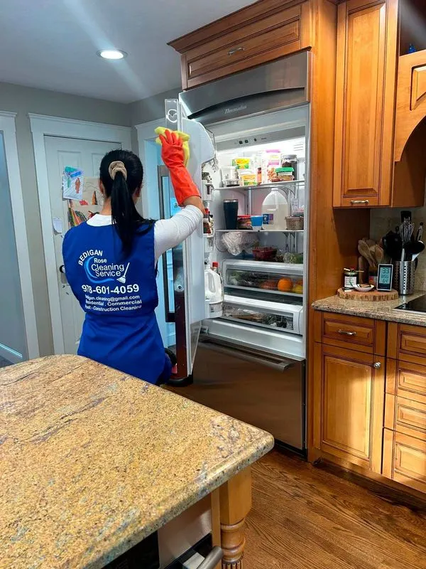 Bedigan cleaner wiping the inside of a refrigerator