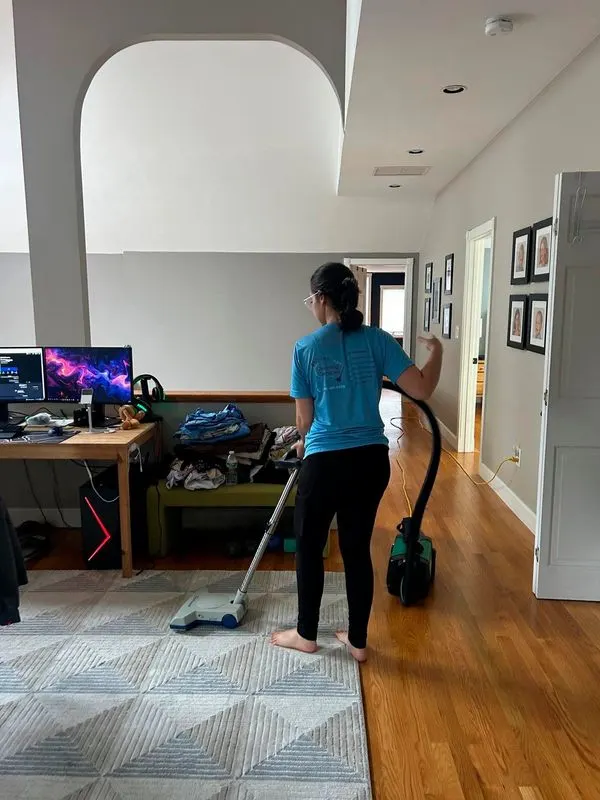 Bedigan cleaner vacuuming a home office