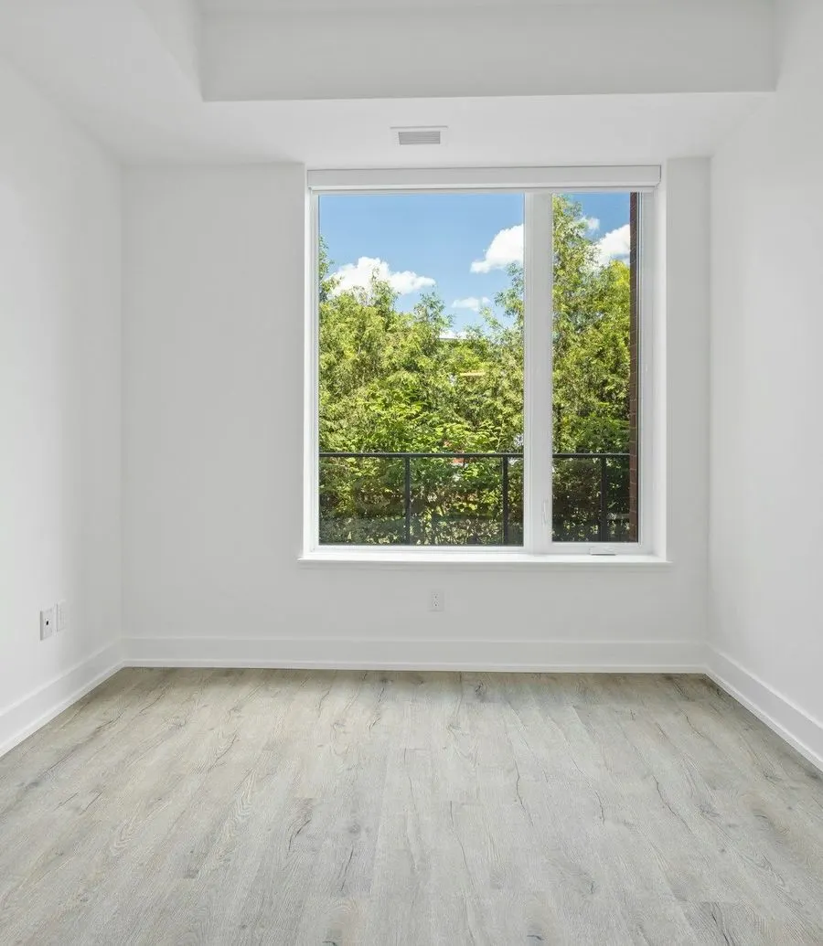 Bright empty room with a clean window and a light floor