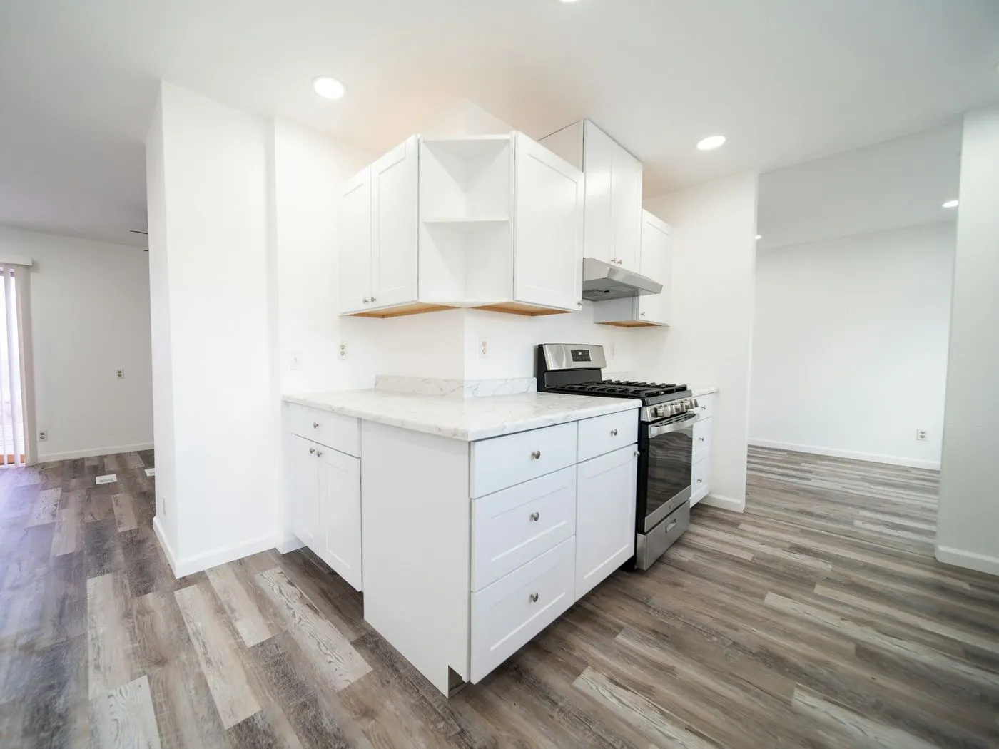 Newly finished kitchen with white cabinets and a new floor, ready to move in